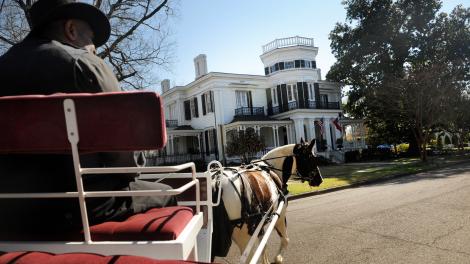 A horse and buggy rolls past a stately home in one of Columbus’s historic neighborhoods A horse and buggy rolls past a stately home in one of Columbus’s historic neighborhoods