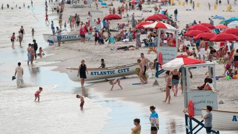 Beachgoers enjoying the sun and surf at the beach in Atlantic City Beachgoers enjoying the sun and surf at the beach in Atlantic City