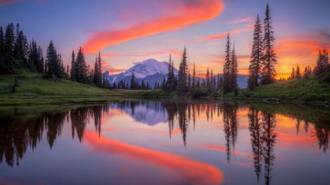 A swath of color punctuates the reflection of the glacier-capped volcanic mountain A swath of color punctuates the reflection of the glacier-capped volcanic mountain