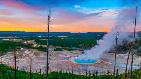 As hot steam rises, a rainbow of colors circles Grand Prismatic Spring As hot steam rises, a rainbow of colors circles Grand Prismatic Spring