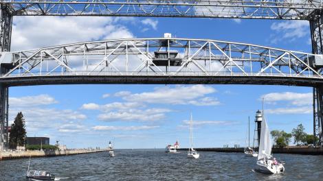 Sailboats pass underneath the Aerial Lift Bridge Sailboats pass underneath the Aerial Lift Bridge