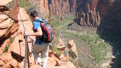 A hiker clings to a cliff at Angels' Landing in Zion National Park A hiker clings to a cliff at Angels' Landing in Zion National Park