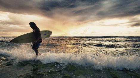 Surfer ending a day spent in the waves Surfer ending a day spent in the waves