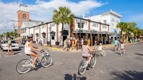 Biking past Sloppy Joe's Bar on Duval Street in Key West Biking past Sloppy Joe's Bar on Duval Street in Key West