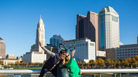 Posing with the deer sculpture in front of the city skyline on the Scioto Mile Posing with the deer sculpture in front of the city skyline on the Scioto Mile