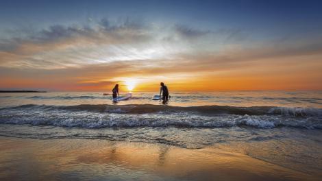 Stand-up paddleboarding at sunrise on Lake Huron in Alpena Stand-up paddleboarding at sunrise on Lake Huron in Alpena