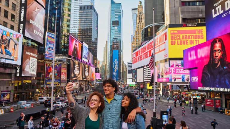 Snapping a selfie in bustling Times Square in the heart of New York City Snapping a selfie in bustling Times Square in the heart of New York City