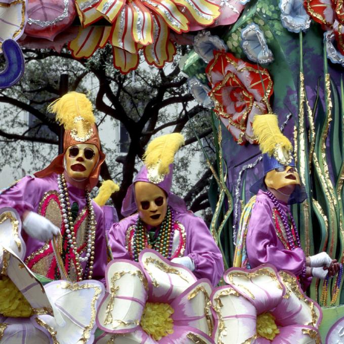 Costumed participants on a Mardi Gras float Costumed participants on a Mardi Gras float
