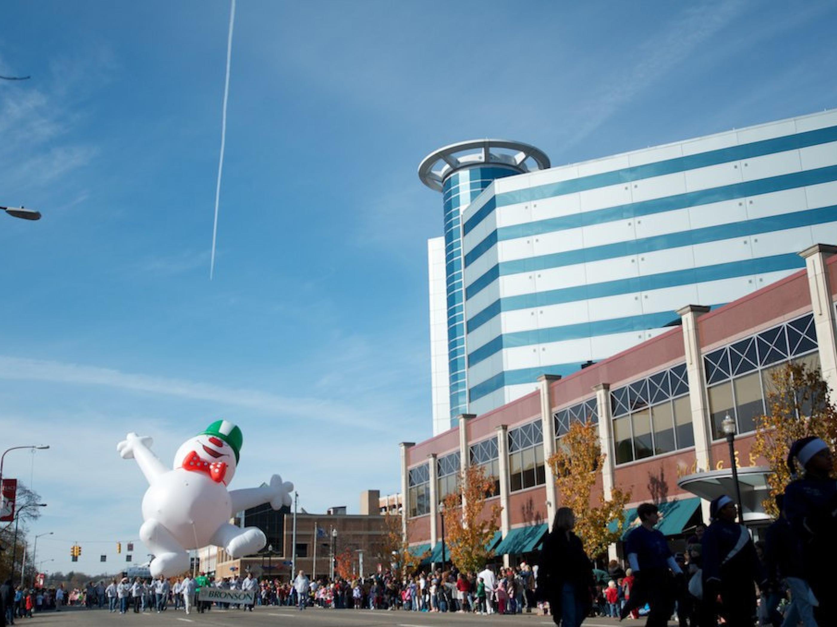 The holiday parade led by a cheerful snowman The holiday parade led by a cheerful snowman
