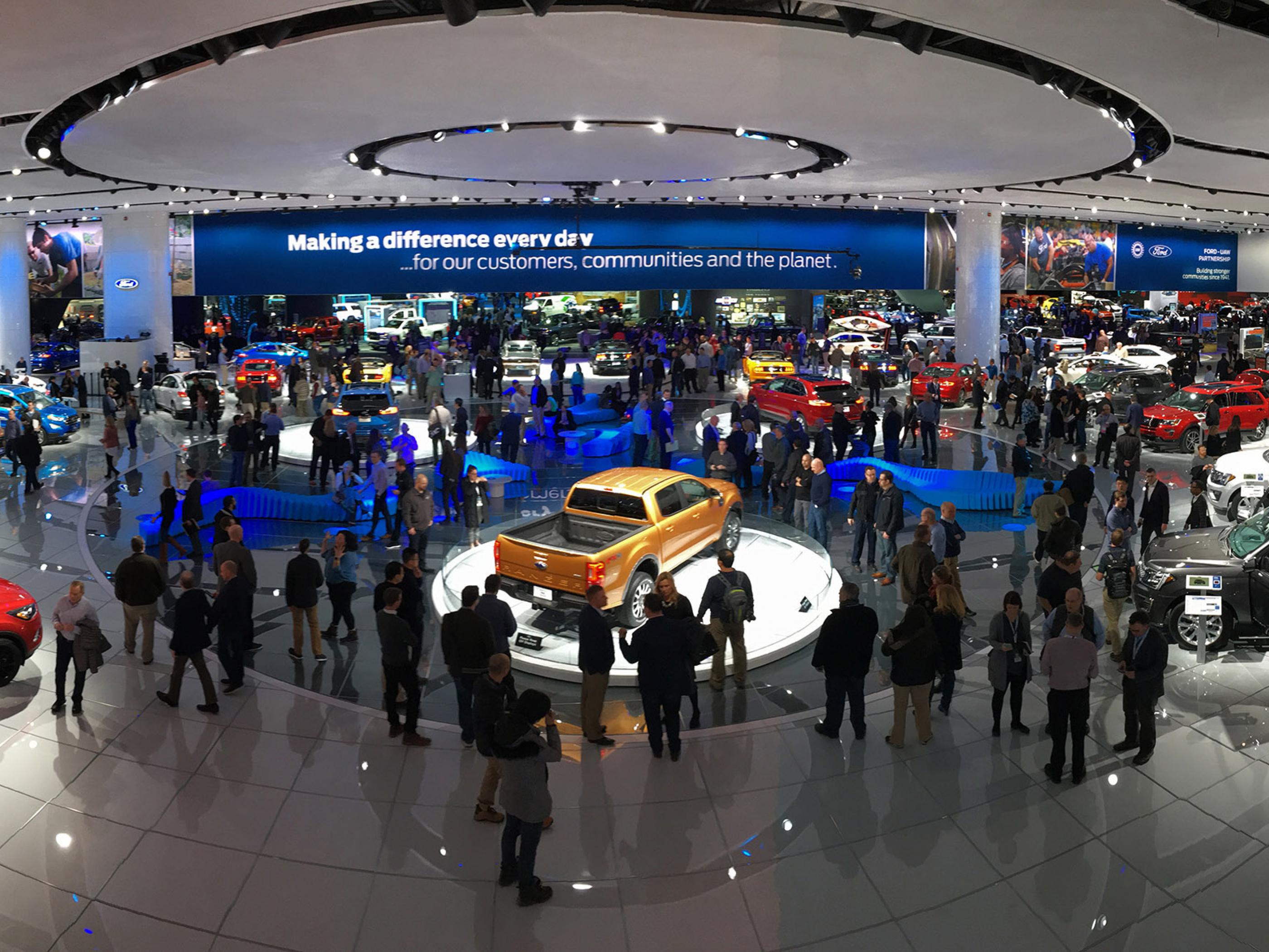 Browsing displays at the North American International Auto Show in Detroit Browsing displays at the North American International Auto Show in Detroit