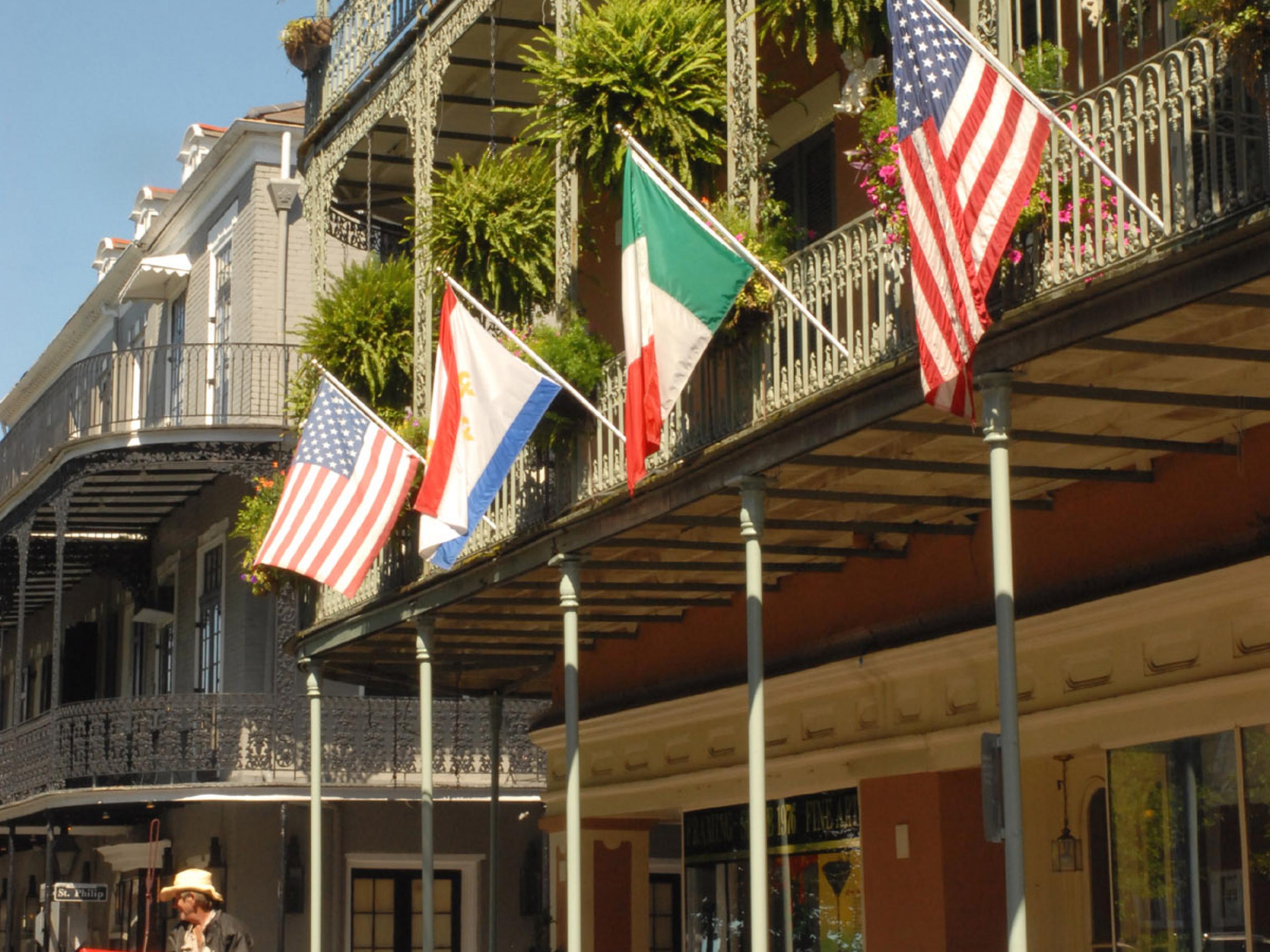Flags hanging from the balconies in the French Quarter Flags hanging from the balconies in the French Quarter