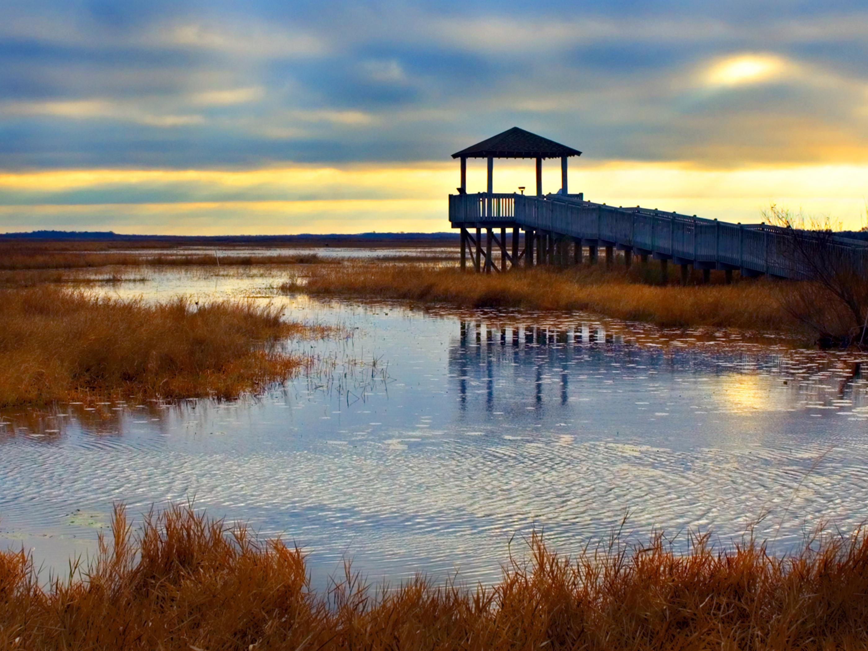 Sunrise over the marsh along the Creole Nature Trail All-American Road Sunrise over the marsh along the Creole Nature Trail All-American Road