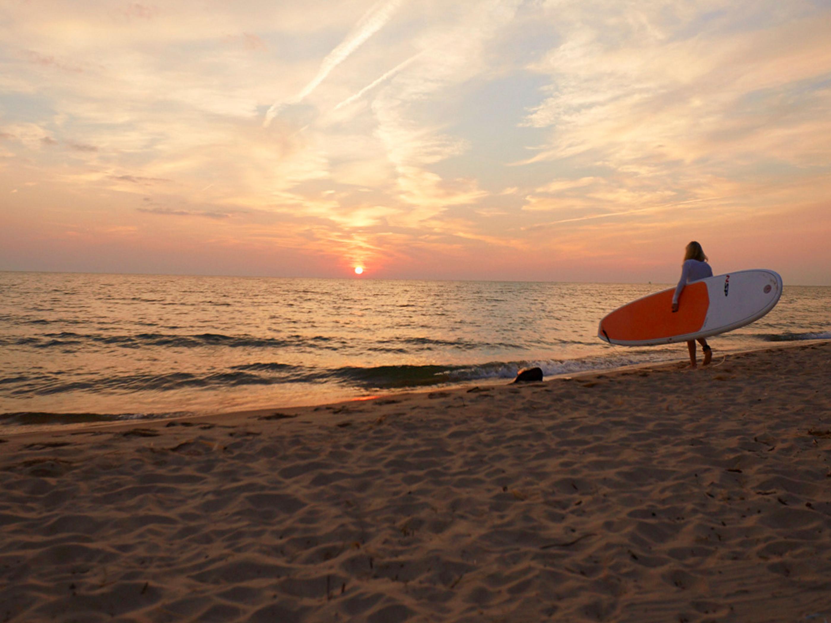 Paddleboarding at dusk in Grand Haven Paddleboarding at dusk in Grand Haven