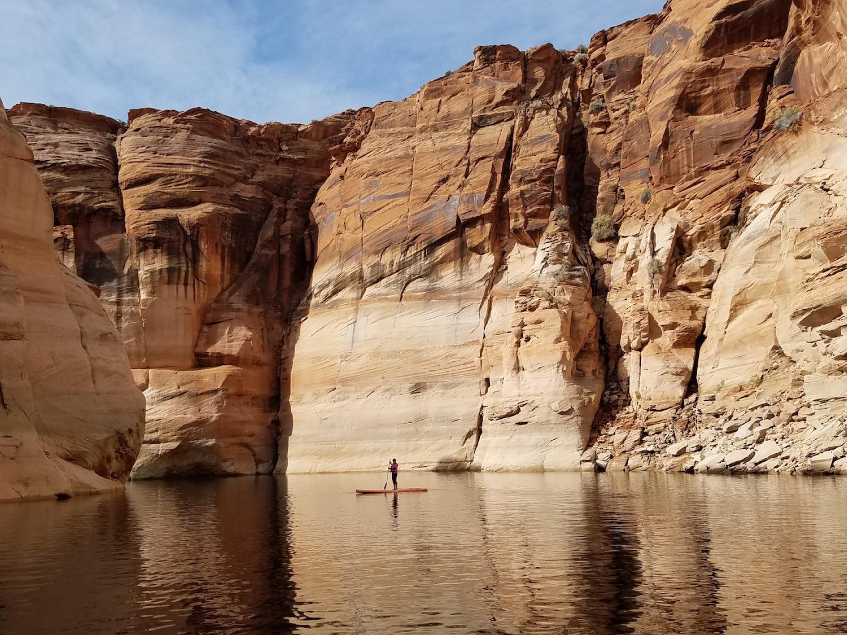 Stand up paddleboarding on Lake Powell in Arizona Stand up paddleboarding on Lake Powell in Arizona