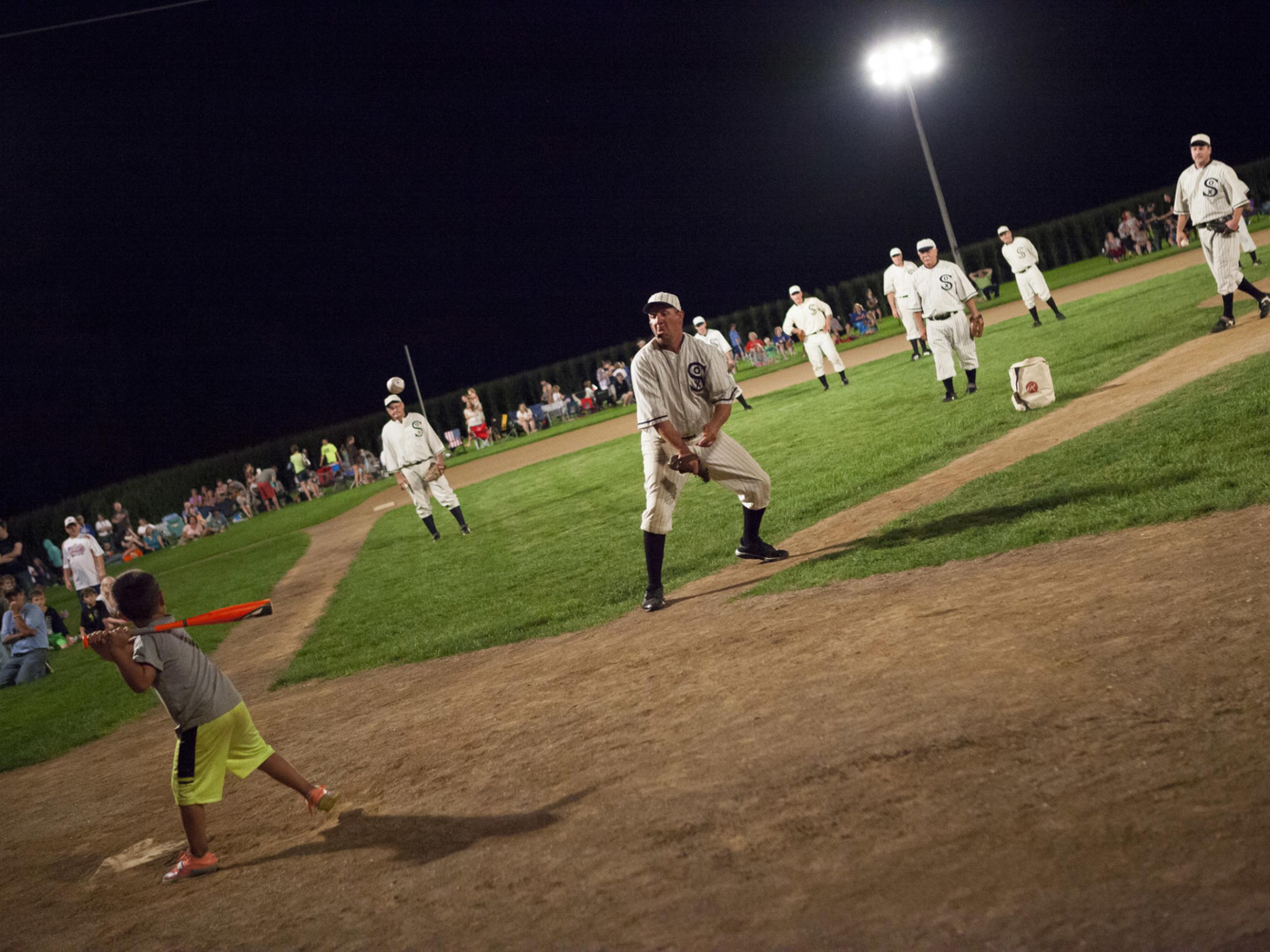 Playing a game at the Field of Dreams Movie Site in Dyersville, Iowa Playing a game at the Field of Dreams Movie Site in Dyersville, Iowa