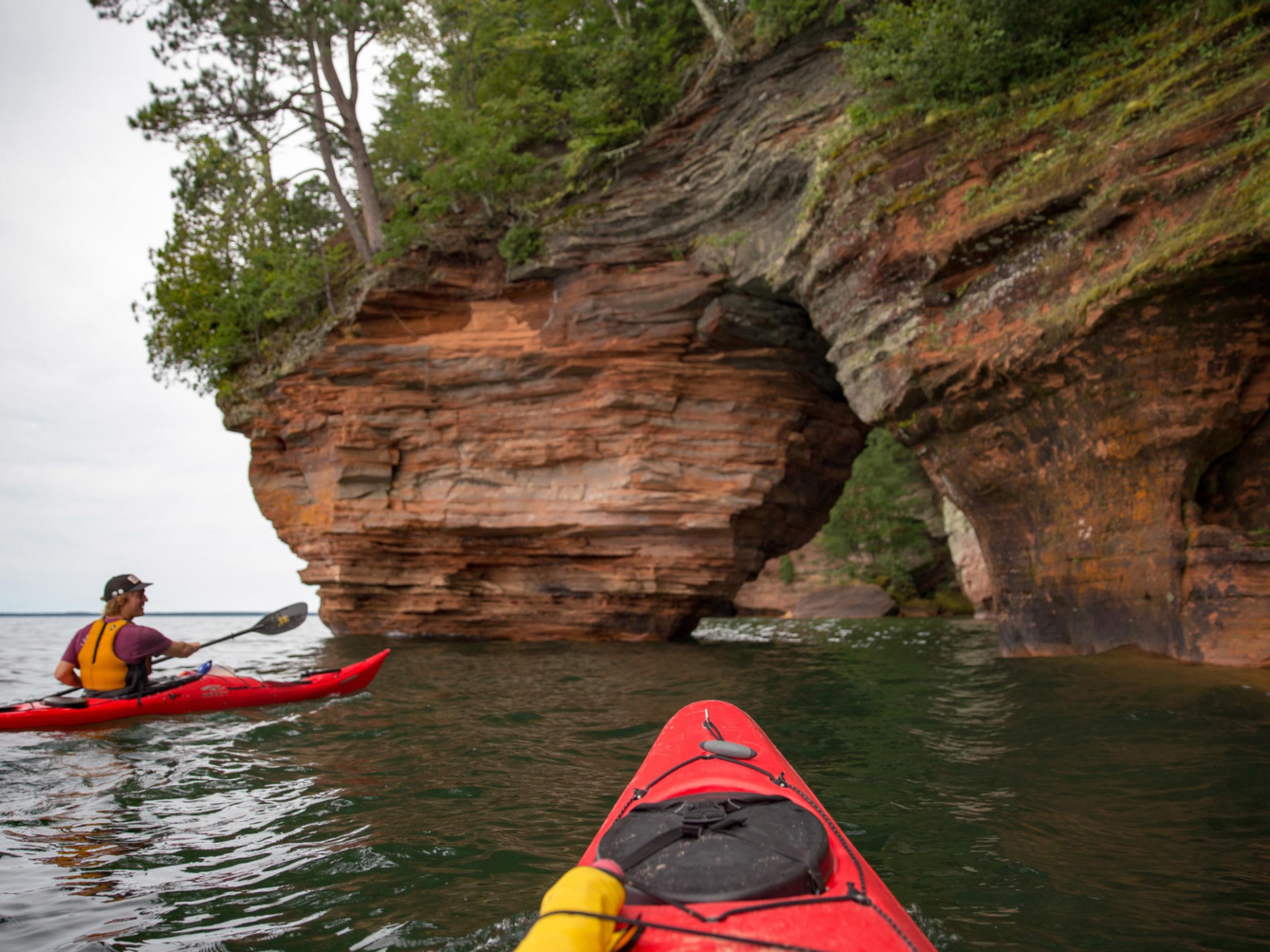 Kayaking along the rocky shore of Apostle Islands National Lakeshore in Wisconsin Kayaking along the rocky shore of Apostle Islands National Lakeshore in Wisconsin