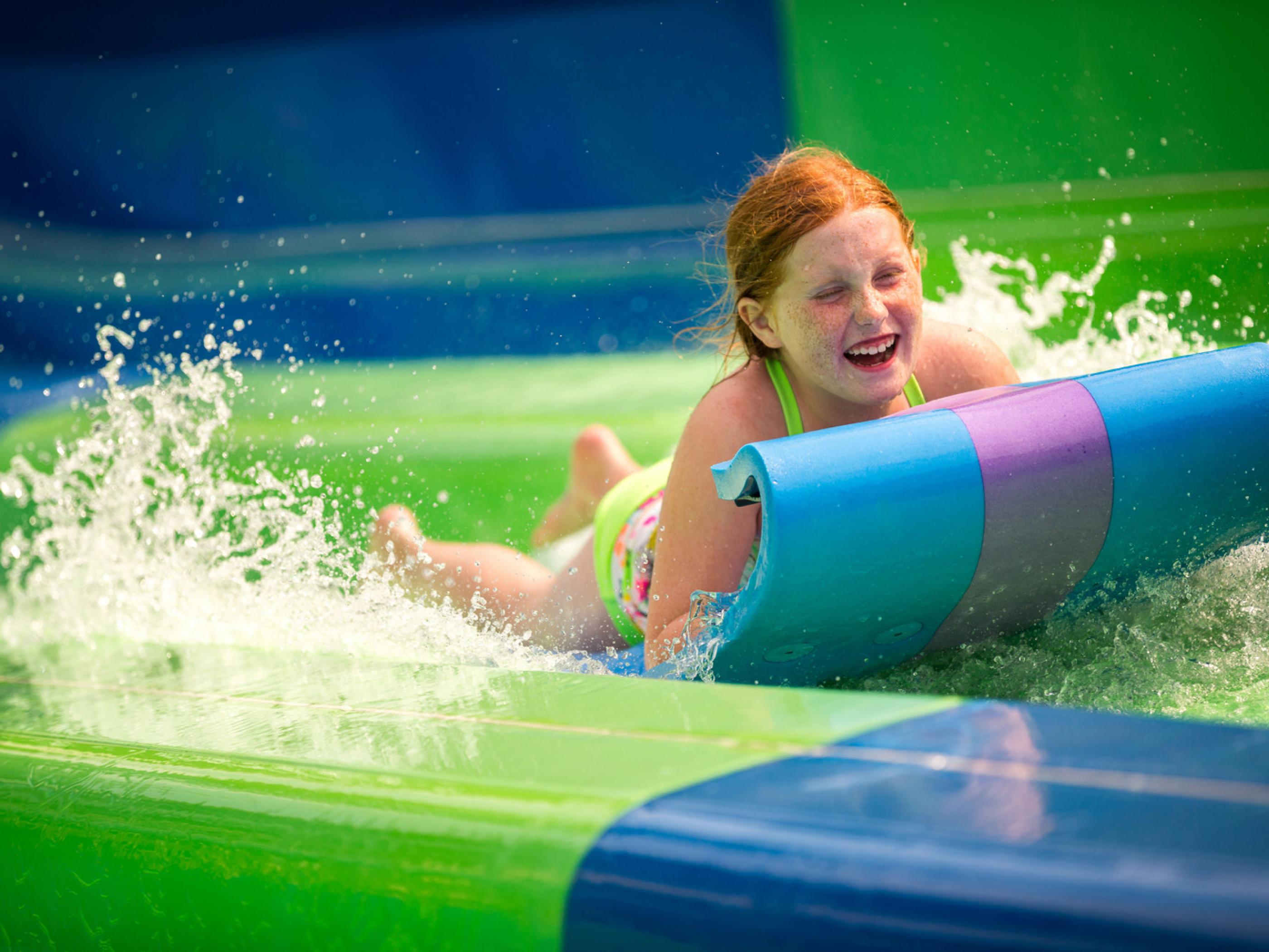 Riding a water slide at Noah’s Ark Waterpark in Wisconsin Dells Riding a water slide at Noah’s Ark Waterpark in Wisconsin Dells