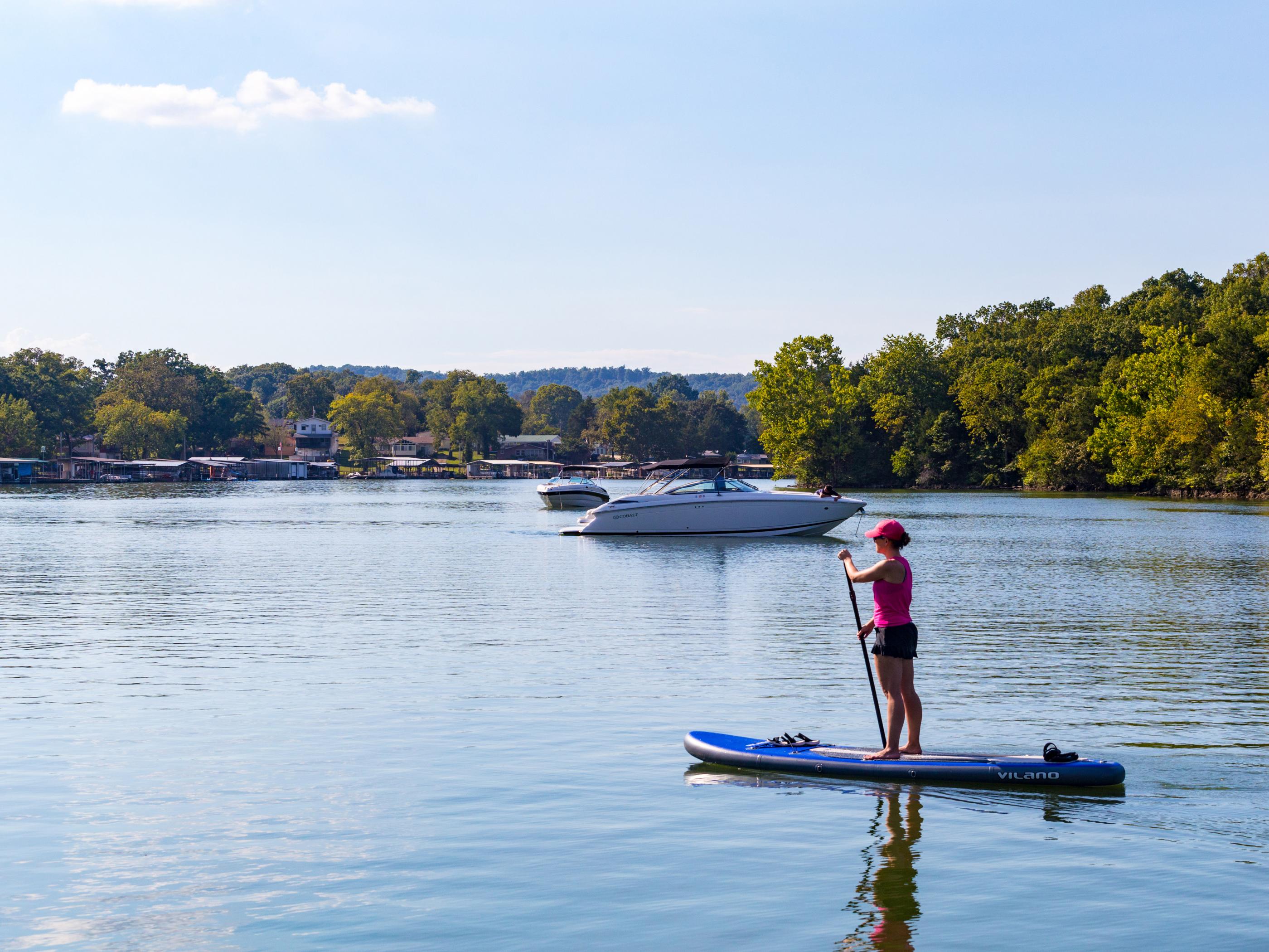 Stand-up paddleboarding on Lake of the Ozarks in Missouri Stand-up paddleboarding on Lake of the Ozarks in Missouri