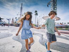 All smiles while playing on a splash pad All smiles while playing on a splash pad