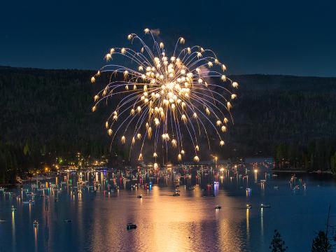 Fireworks exploding over the picturesque Bass Lake for Independence Day Fireworks exploding over the picturesque Bass Lake for Independence Day