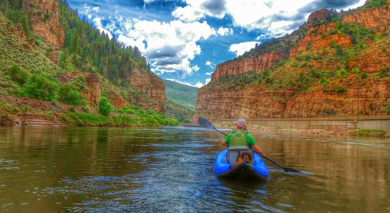 Kayaker paddling the Colorado River through Glenwood Canyon Kayaker paddling the Colorado River through Glenwood Canyon